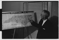 Man with NC organizational plan map 